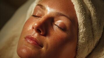 Relaxation Moment With a Hot Towel Compress on the Forehead in Soothing Warm Lighting photo