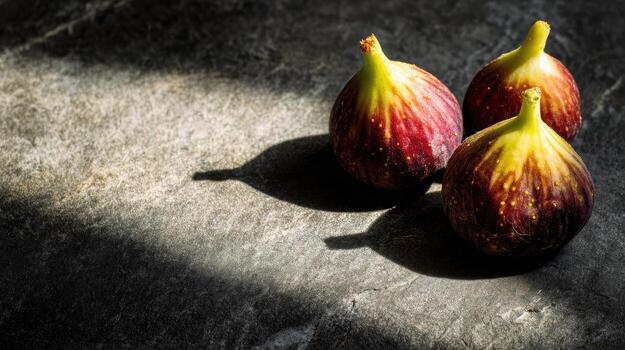 Fresh Figs Basking in Natural Light on a Textured Stone Slab, Casting Interesting Shadows, With One Third of the Composition Remaining Untouched photo