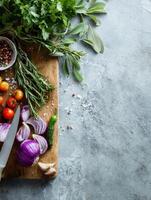 Food Preparation With Fresh Herbs and Chopped Vegetables on a Wooden Board in a Bright Kitchen Setting photo