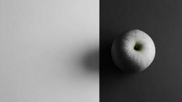 Minimalist Grayscale Layout Featuring a Single Colored Apple Emphasizing Contrast and Simplicity in Composition photo