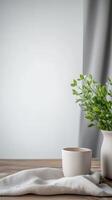 Minimalist Home Decor Serene Green Plant in Vase with Ceramic Cup on Wooden Table, Bathed in Soft Natural Light, Perfect for Tranquil Interiors. photo