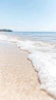 Serene Ocean Waves Gently Kissing Golden Sands A Tranquil Coastal Scene Under a Bright Blue Sky, Perfect for Relaxation and Summer Escapes photo