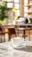 Steaming Latte Art in a Bright Cafe A Serene Morning Moment with Rich Coffee and Delicate Foam Design on a Marble Table photo