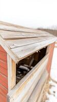 Rustic Weathered Wooden Shed in Winter An Abandoned Farm Structure with Rich Textures and Fading Red Paint in a Serene Rural Landscape photo