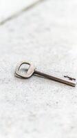 Vintage Metal Key Resting on a Textured Concrete Surface, Symbolizing Access, Opportunity, and Unlocking Hidden Potential in a Minimalist Composition photo