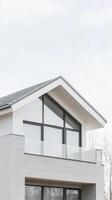 Striking Modern Home Architecture A Minimalist White Facade with Expansive Glass Windows and a Sleek Grey Roof Design photo