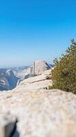 Majestic Half Dome Vista Iconic Granite Peak Soaring Above Yosemite Valley Under a Clear Blue Sky. Breathtaking Natural Landscape. photo