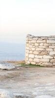 Ancient Stone Wall Ruin Overlooking Vast Landscape A Timeless Architectural Structure with Historic Charm and Serene Horizon Views photo