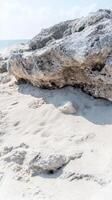 Textured Coastal Beauty Weathered Rock and Golden Sands by the Azure Ocean. A Serene Natural Landscape for Tranquil Escapes. photo