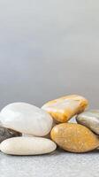 Serene Collection of Polished River Stones A Tranquil Array of Natural Pebbles in Earth Tones for Zen Decor and Peaceful Backgrounds photo