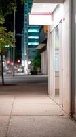 Empty Urban Sidewalk at Night with Illuminated Building and Distant City Lights, Serene Evening Streetscape photo
