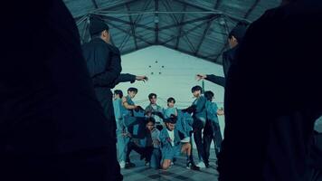 Group of young people in denim outfits dancing in an urban setting with dynamic poses and expressions during the night video