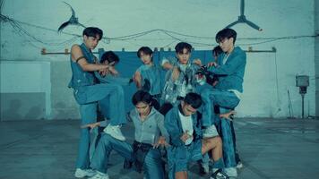 Group of young people in denim outfits dancing in an urban setting with dynamic poses and expressions. video