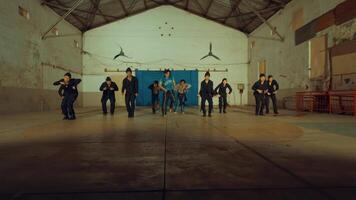 Group of dancers practicing in a studio with a female dancer in the center. video