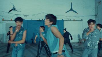 Group of young people practicing dance moves in a studio with a rustic vibe. video