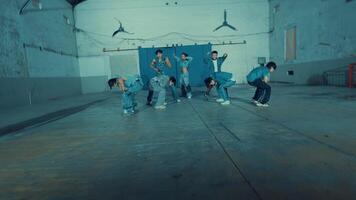 Group of young dancers practicing in a studio with industrial vibes. video