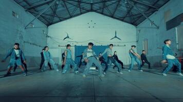 Group of people practicing dance moves in a spacious industrial-style studio. video