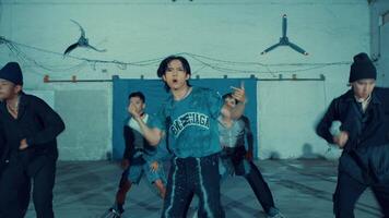 Blurred motion of young men running in an urban setting with barbed wire and a blue wall video