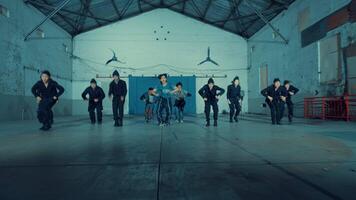 Diverse group of people dancing in a warehouse, expressing freedom and energy through movement. video