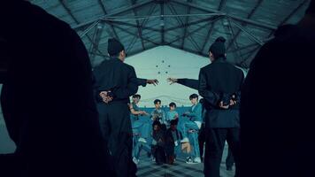 Diverse group of young people dancing in an industrial-style room with cool lighting video