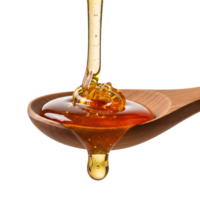 Honey is dripping from a wooden spoon isolated on transparent background png