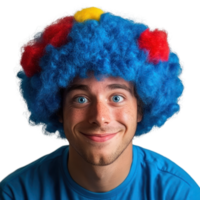 Cheerful young man with colorful clown wig smiling against a plain background during a fun event png