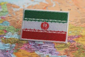 An eco style Iranian flag stitched from fabric and thread, placed precisely on Iran location on a world map. A symbolic image combining patriotism, sustainability, and travel inspiration. photo
