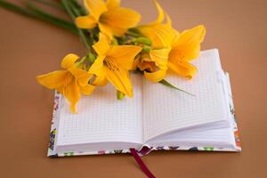 Yellow lilies with notebook for Mother's Day inspiration photo