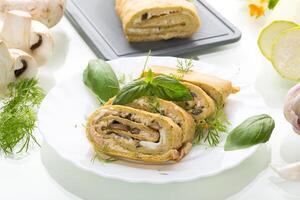 Zucchini roll with cheese and mushrooms, isolated on a white background photo