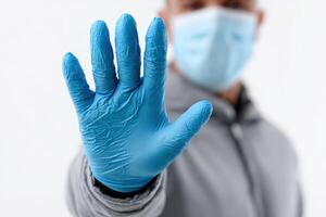 Stop sign with glove and mask in the pandemic photo
