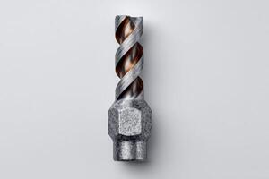 Metal drill bit with spiral flutes on a white background photo