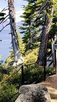 View, POV walking down mountain stone path by lake Tahoe in California. Walking tourist route near the lake in the mountains video