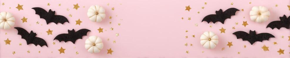 Halloween mockup with bats, pumpkins, and stars on pastel pink background photo