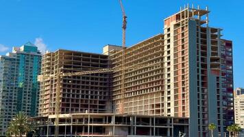 A contemporary building under construction in a bustling urban setting, showcasing modern architecture. photo