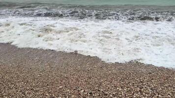A truly captivating scene showcasing gentle ocean waves gracefully crashing onto a stunning, pebbly beach photo