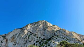 Enjoy the breathtaking and extraordinary view of a rocky mountain landscape set against a clear blue sky photo