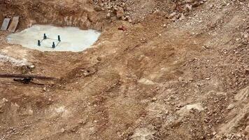 Excavation site with earth mounds and serene turquoise water backdrop. Perfect for construction and landscape themes. photo