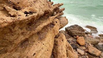 The stunning coastal scenery features unique rock formations and gentle waves rolling in beautifully photo