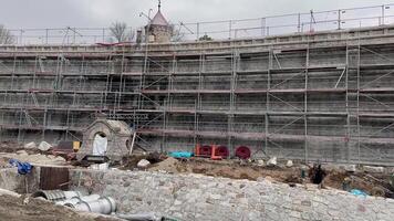 A view of a busy construction site with scaffolding, materials, and ongoing work processes in action photo