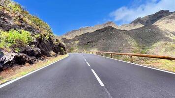 A beautiful winding road through mountains showcasing nature's stunning landscape and clear blue skies. video