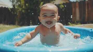 Happy baby splashing in blue inflatable pool on sunny day photo