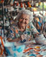 an elderly woman is painting a pottery vase photo