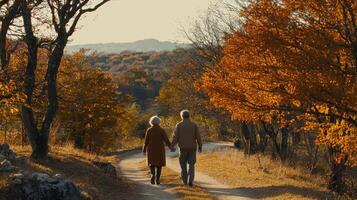 couple walks hand in hand along scenic autumn path surrounded by trees photo