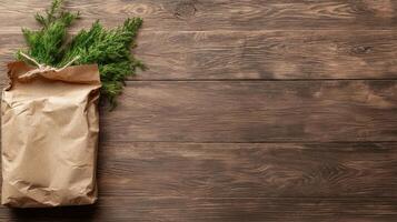 paper bag with fresh green herbs on wooden background photo