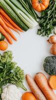 Fresh vegetables and fruits arranged on white background, creating vibrant frame photo