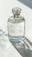 Elegant glass perfume bottle with golden accents casting soft shadow photo