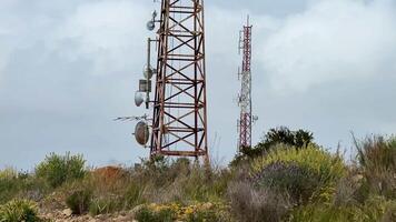 Here is a detailed and closeup view of a telecommunication tower that features many antennas and essential equipment video