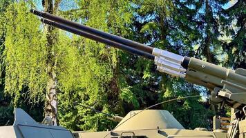 A detailed and impressive view of tank artillery proudly showcasing its advanced design in a lush green environment video