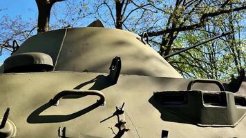 A military tank is showcased in a lush green backdrop, emphasizing its design, functionality, and aesthetics video