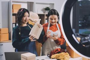 Two women in aprons standing in front of a camera photo